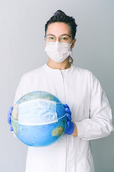 Conceptual image of a doctor holding a globe with a mask, symbolizing global health.